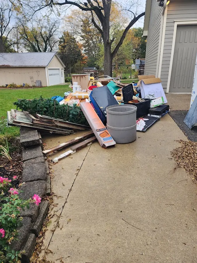 Dumpster being loaded with debris for Commercial Dumpster Rental in Buxton